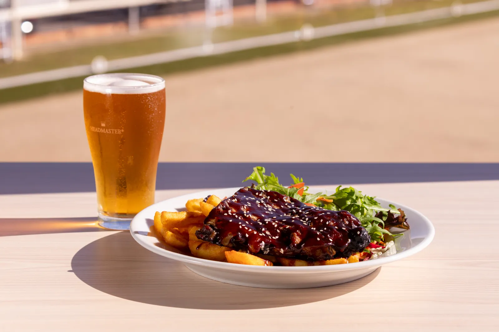 BBQ pork ribs with chips and salad and a cold beer